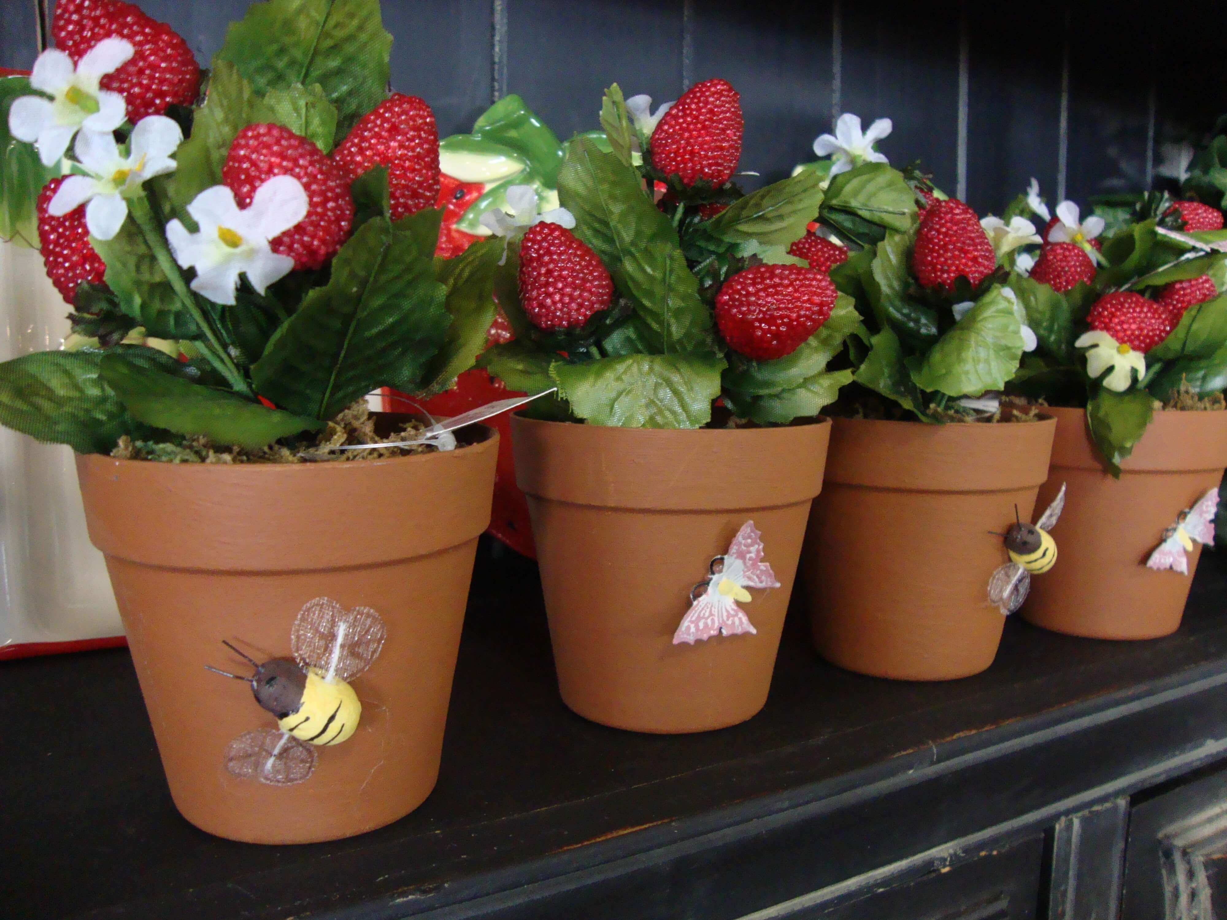 Fresh strawberries growing in a small garden container